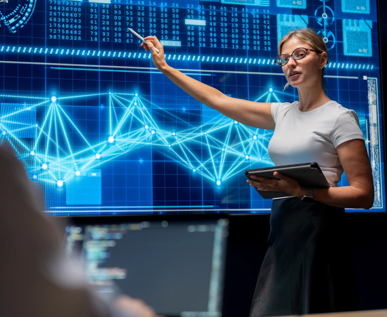Businesswoman presenting data insights with digital graphs in the background.